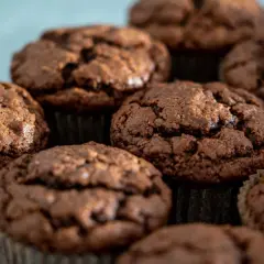 Kilka czekoladowych muffinek w papierowych papilotkach, zbliżenie.